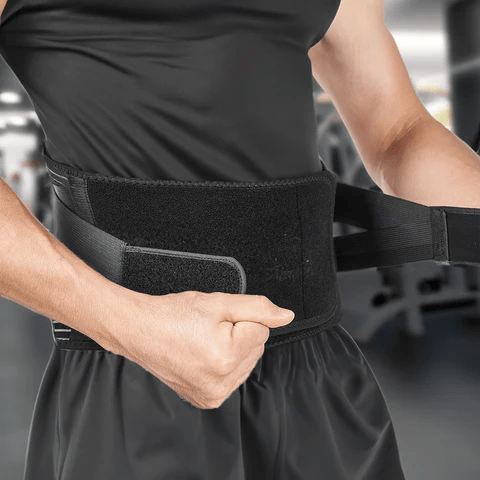 Man adjusting the Lower Back Brace Support Belt, designed to provide adjustable compression and lower back pain relief. This back brace is ideal for posture correction and is considered one of the best back braces for lower back pain during exercise or daily use.
