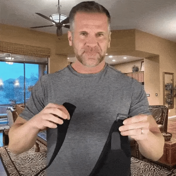Man demonstrating how to wear a shoulder brace for optimal shoulder support and compression. The best shoulder brace for pain relief and injury recovery.